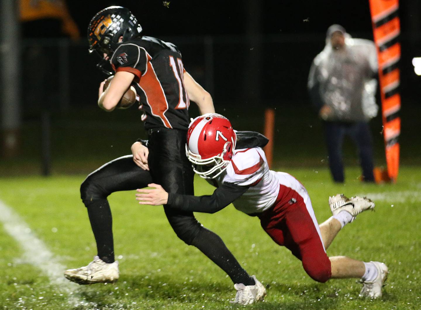 Flanagan-Cornell/Woodland's Payton Quaintance sprints down the field while South Beloit's Jacob Wilhite chases him down from behind during the first round of the 8-man football playoffs on Friday, Oct. 27, 2023 in Flanagan.