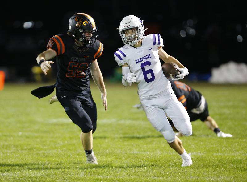 Hampshire's Zachary Vodraska scrambles from Crystal Lake Central's Tyler Julitz during the varsity football game on Friday, September 17, 2021 at Crystal Lake Central High School in Crystal Lake, IL.