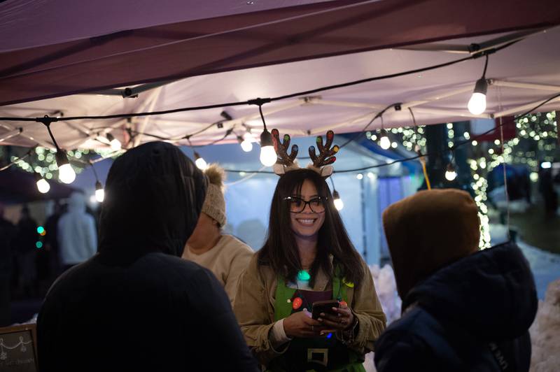 Yoana Rodriguez helps customers at the vendor tent for Antojitos Mexicanos at the Manteno Christmas celebration on Saturday, December 6, 2025.
