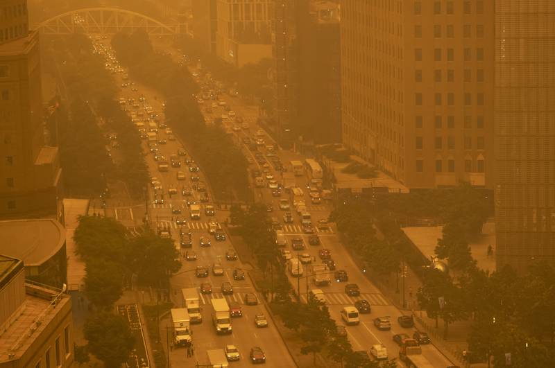 Traffic moves along Wednesday, June 7, 2023, in New York, amidst smokey haze from wildfires in Canada. Smoke from Canadian wildfires poured into the U.S. East Coast and Midwest on Wednesday, covering the capitals of both nations in an unhealthy haze, holding up flights at major airports and prompting people to fish out pandemic-era face masks. (AP Photo/Andy Bao)