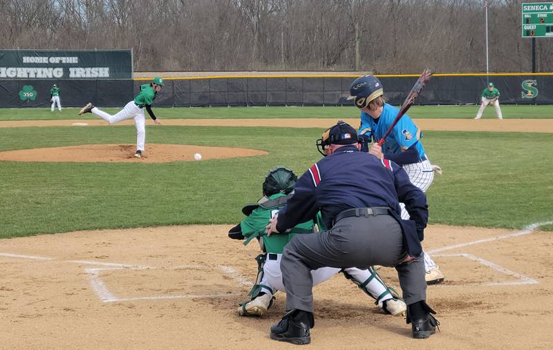 Seneca starting pitcher Matt Cruise fires a pitch to Marquette Academy's Logan Nelson in the first inning of Tuesday's Tri-County Conference game in Seneca on April 19, 2022.