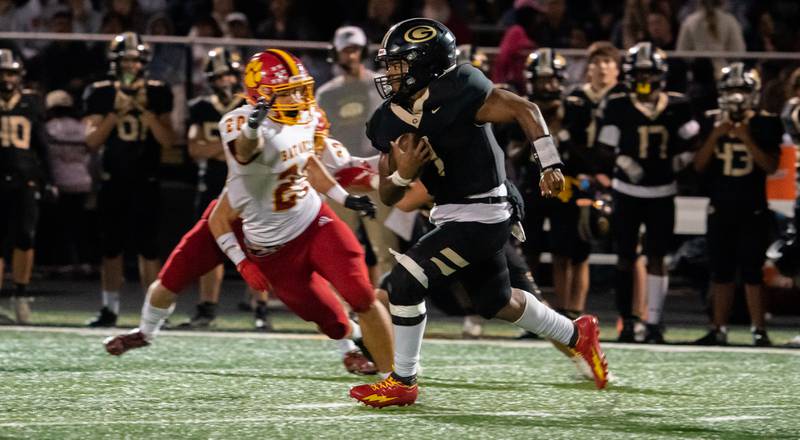 Glenbard North's Bland Justin (1) carries the ball on a keeper against Batavia’s Brody Osborne (20) during a football game at Glenbard North High School in Carol Stream on Friday, Sep 23, 2022.
