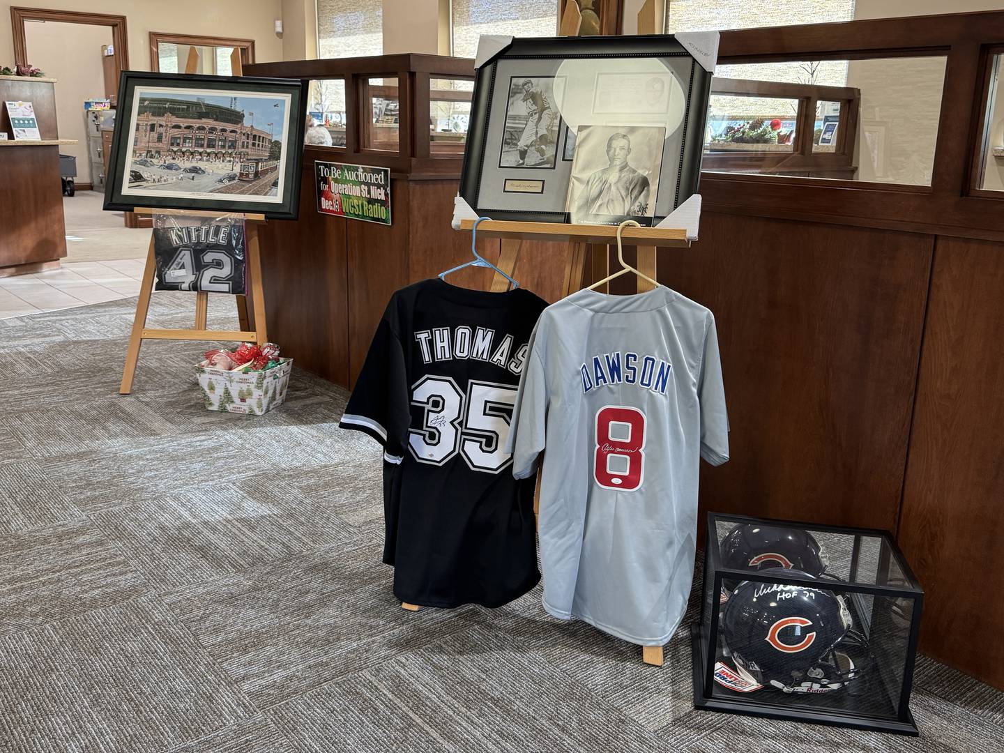 There are many pieces of sports memorabilia up for auction, including an autographed Frank Thomas jersey, an autographed Andre Dawson jersey, an autographed Dick Butkus helmet, and more.