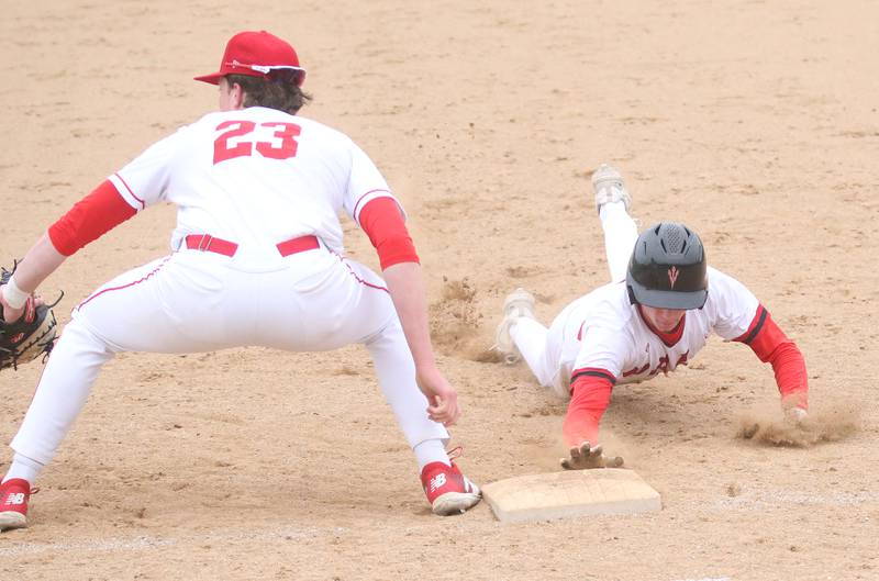 Hall's Hunter Edgcomb dives back to the bag at first as Ottawa's Jackson Mangold catches the late throw on Tuesday, April 1, 2025 at Ottawa High School.