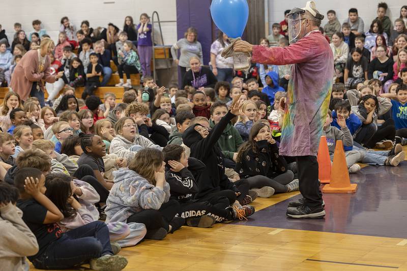 Students wait for the pop of a balloon during an experiment by Steve Belliveau Friday, March 7, 2025, during his “Getting Excited About Science” program.