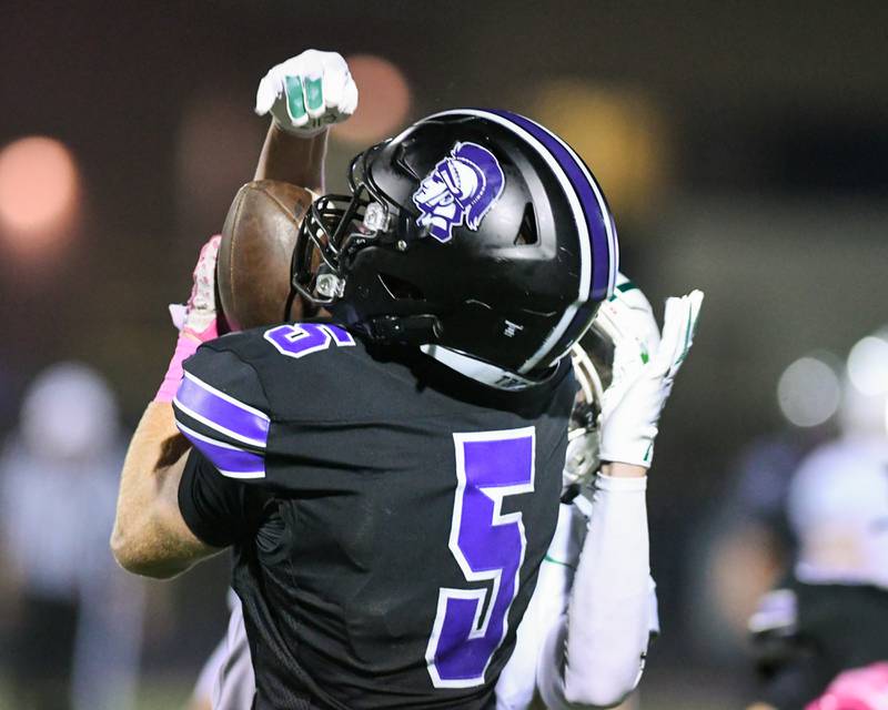 Downers Grove North's Max Troha (5) catches a pass during the game on Friday Oct. 10, 2025, while being defended by Yok High School held at Downers Grove North High School.