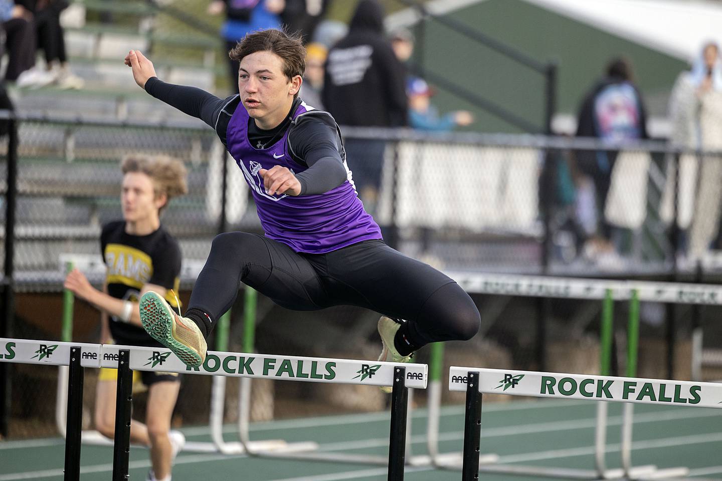 Dixon’s Tyson Dambman clears a hurdle in the 110 hurdles Friday, April 21, 2023 at the Rock Falls Rocket Invitational.