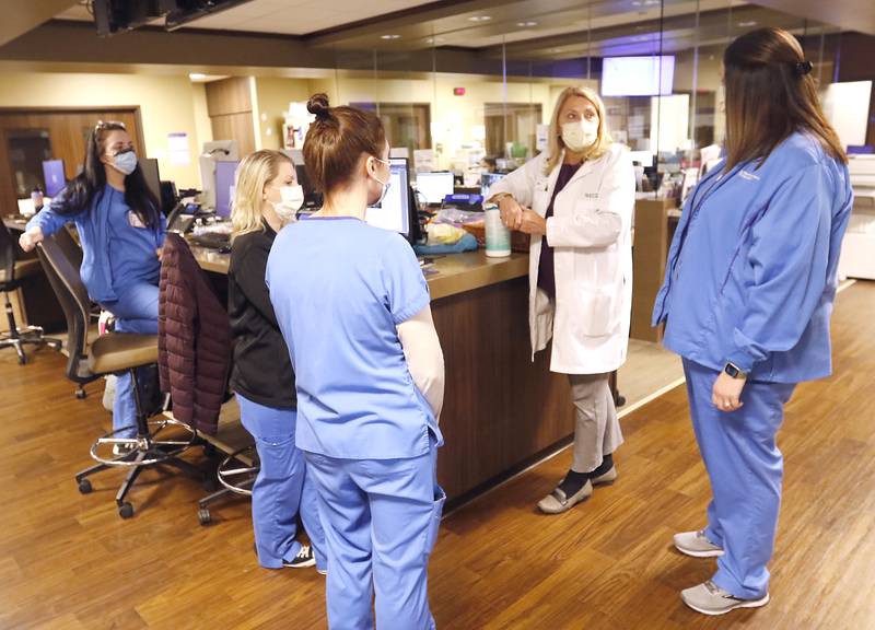 Kim Armour, a Vice President and Chief Nurse Executive at Northwest Medicine Huntley Hospital, talks with members of the hospital’s emergency department patient care team Wednesday, Feb. 16, 2022, while making rounds at the hospital.