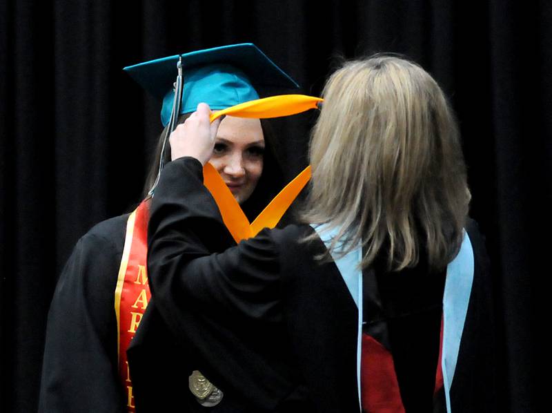 Valedictorian Kamryn Butenshoen receives her award from Assistant Principal Jennifer Spear Saturday, May 14, 2022, during the graduation ceremony at Woodstock North High School.