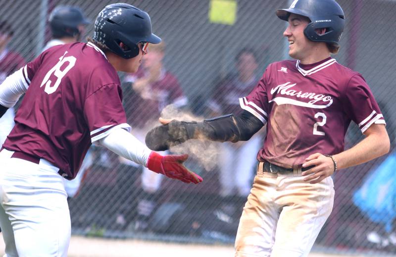 Marengo’s  Robert Heuser, right, is greeted by Drew Litchfield, left, after scoring against Rockford Christian in IHSA Class 2A Regional Title Game action baseball at Richmond-Burton High School in Richmond  on Saturday, May 24, 2025.