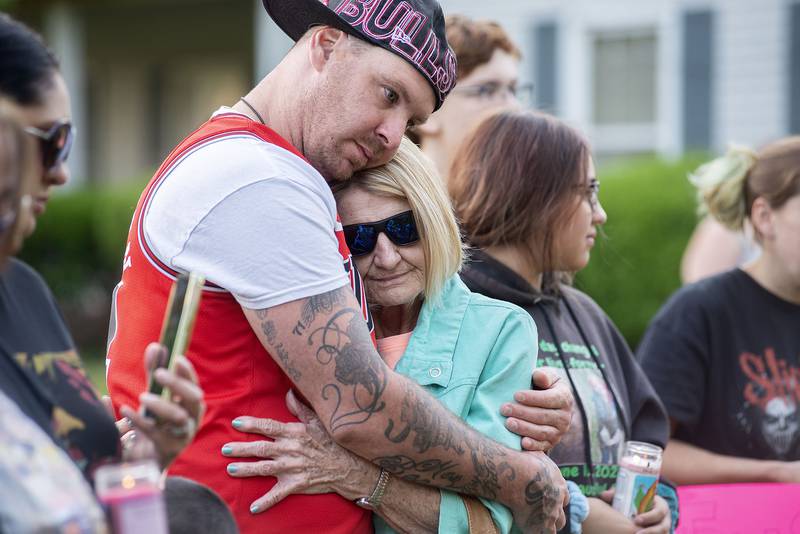 Brandon Adams hugs grandmother Kathy Hall Wednesday, June 1, 2022. The two were attending a vigil in memory of three victims of arson that took place in 2000 at the Western Apartments in Sterling. One of the victims, Carrie A. (Hall) Hose is Adams’ son.