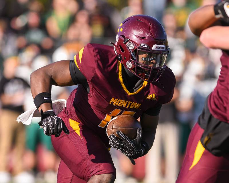 Montini Catholic's Charles Flowers (15) runs the ball during the 4A quarterfinals game while takin on Coal City  on Saturday Nov. 15, 2025, held at Montini Catholic High School.