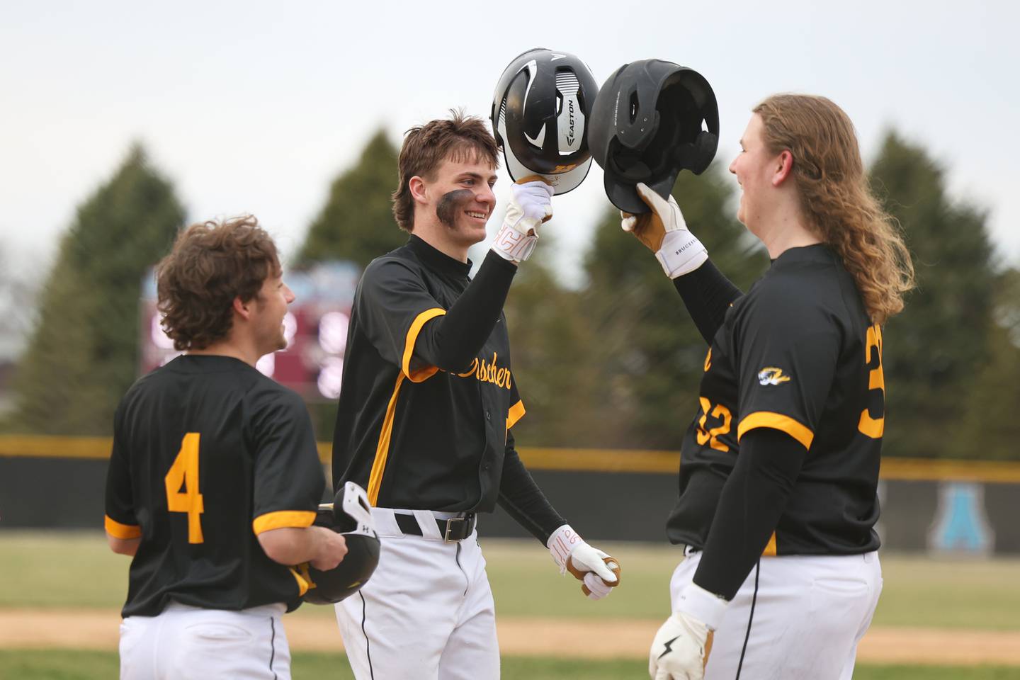 Herscher's Tanner Jones celebrates his homerun with teammates Nash Brubaker, right, and Brennen Gessner during the Tigers' 19-4 victory over Kankakee on Friday, March 21.