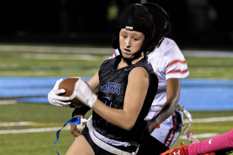 Willowbrooks's Mckenzie Edison dodges the defense during a varsity flag football IHSA State Quarterfinals game against Kenwood, held at Willowbrook High School on Oct. 17, 2025.