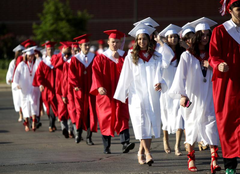 Benet graduates process into Gilbert-Baumgartner Stadium for the school’s commencement ceremony in Lisle on Thursday, May 25, 2023.