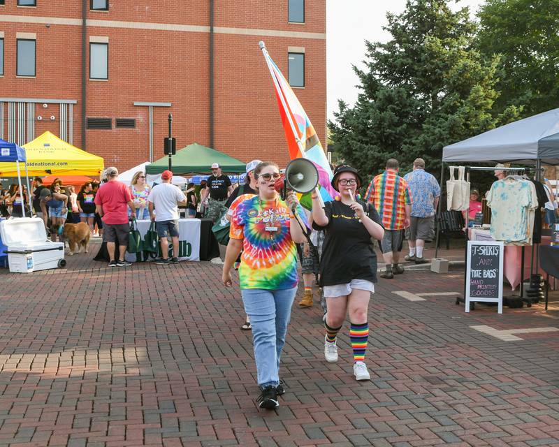 Beth Ganion of DeKalb and brother-in-law Tony Titus, a sophomore at Sycamore High School, lead the DeKalb Pride Fest march in downtown DeKalb on Thursday, June 22, 2023.