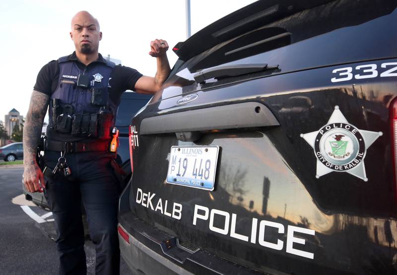 DeKalb Police Officer Justin Hickman by a patrol vehicle Friday, April 19, 2024, outside the DeKalb Police Department.