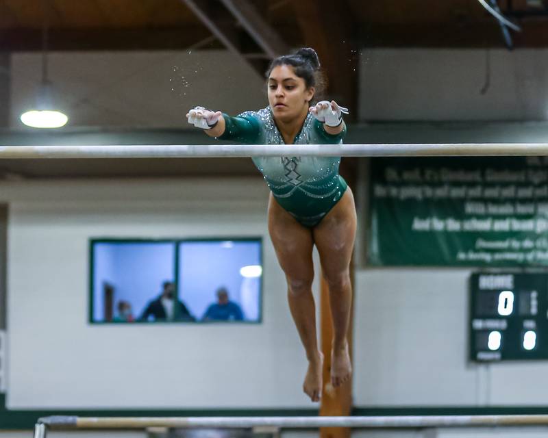 Glenbard West's Alina Bhagwakar performs on uneven parallell bars during the Glenbard West Sectional. Feb 10, 2022.