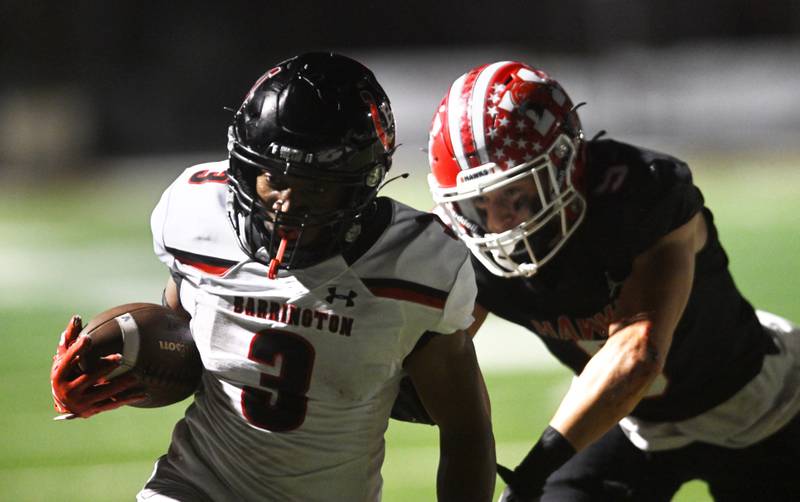 Barrington’s Calvin Jackson scores a touchdown during the first quarter as he gets to the end zone ahead of Maine South’s Mateo Jalenkovic on Friday, Sept. 20, 2024 in Park Ridge.