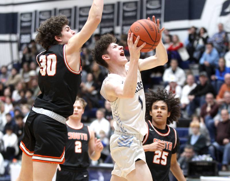 Lake Park’s Camden Cerese (right) gets blocked by Wheaton Warrenville South’s Luca Carbonaro during a game at Lake Park in Roselle on Friday, Feb. 10, 2023.