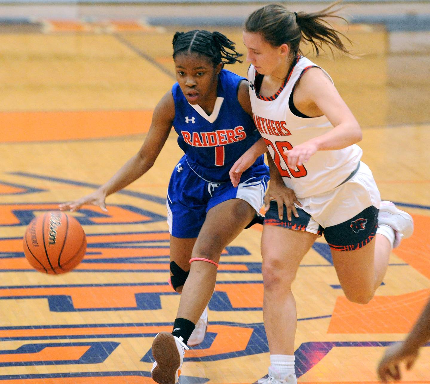 Glenbard South's Rheayanna Ferguson (1) drives against Oswego defender Anna Johnson (20) during a girls varsity basketball game at Oswego High School on Wednesday, Nov. 16, 2022.