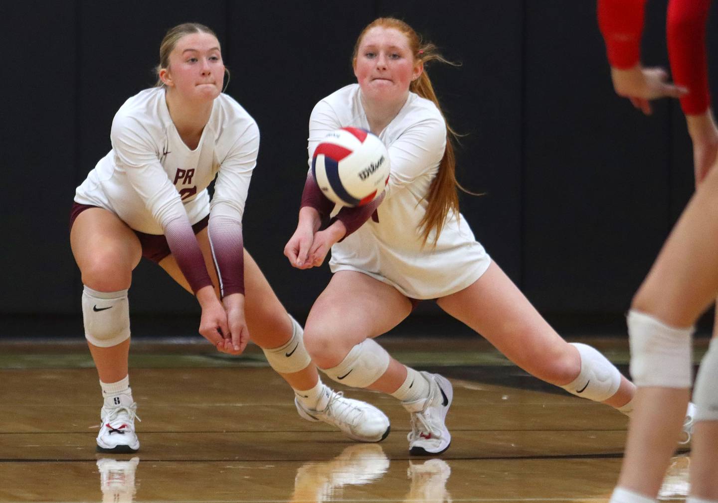 Prairie Ridge’s Ava Bell, left, and Kaelin Bacak play the ball against St. Viator in IHSA Class 3A Super-Sectional girls volleyball at Streamwood High School in Streamwood on Monday, November 10, 2025.