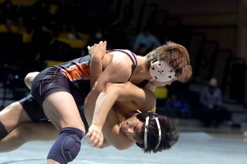 Crystal Lake South’s Erik Gonzalez, bottom, is launched by McHenry’s Chris Moore in a 160-pound match during varsity wrestling at Crystal Lake Thursday night.
