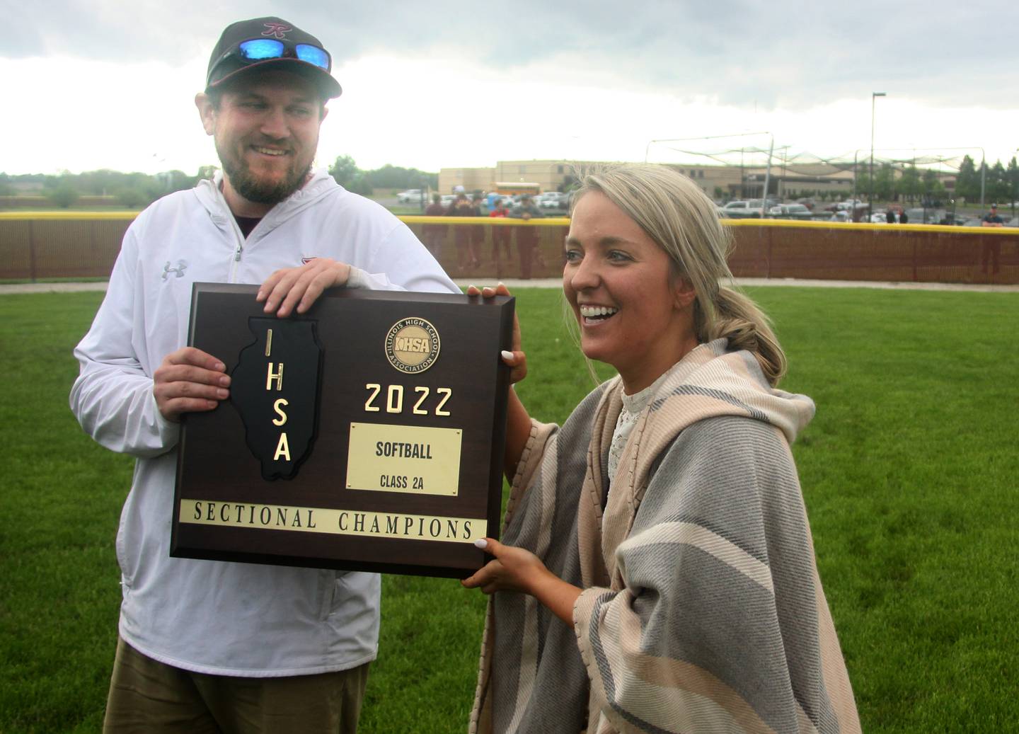 Richmond-Burton’s head coach Tylar Stanton, left, and his fiancee Michelle Serini hoist the hardware after a win over Stillman Valley in softball sectional title game action in Richmond Friday evening.