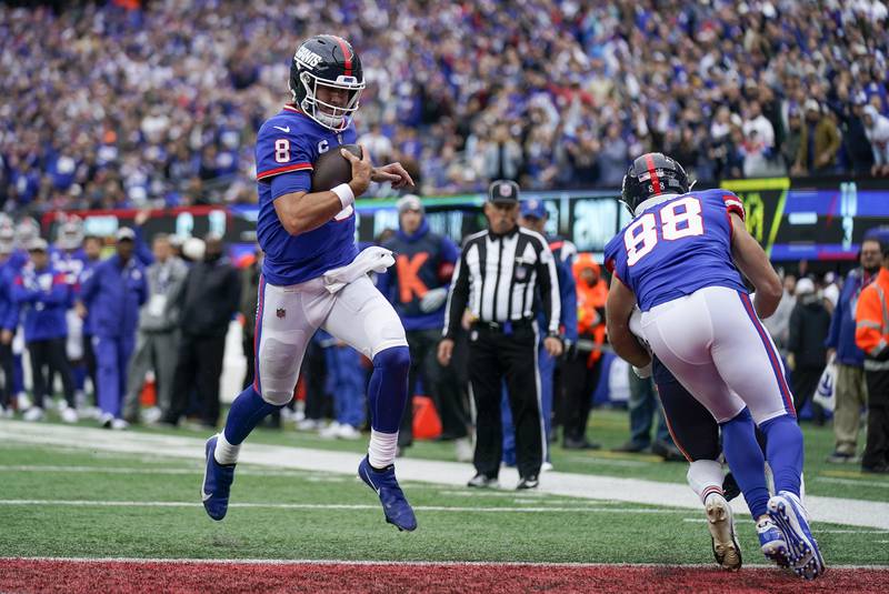 New York Giants quarterback Daniel Jones (8) crosses the goal line for a touchdown against the Chicago Bears during the second quarter of an NFL football game, Sunday, Oct. 2, 2022, in East Rutherford, N.J. (AP Photo/Seth Wenig)