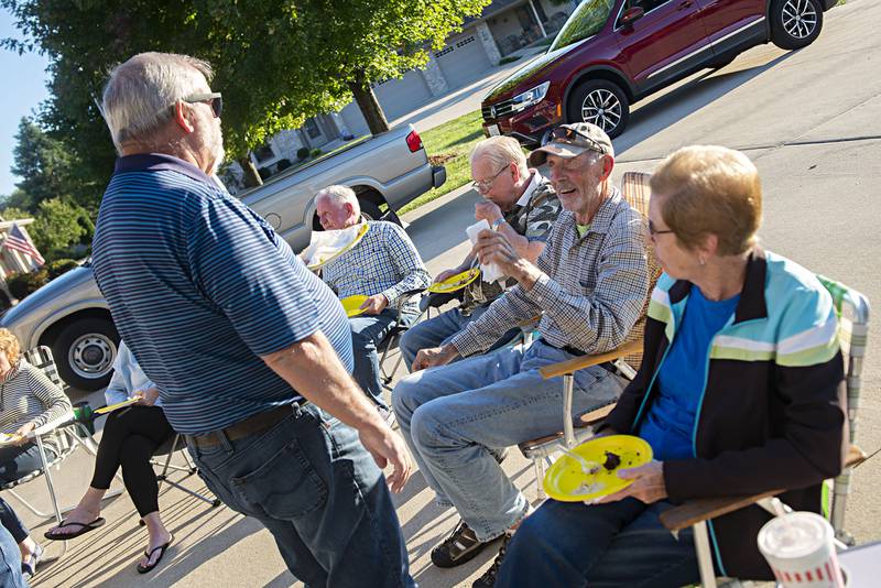 Jeff Kuhn, left, and Bob Hargrave chat during the Autunnwood neighborghood's Garbage Party in Dixon.