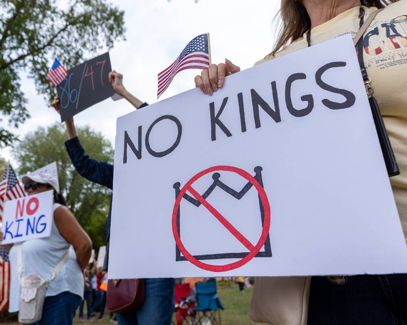 Protesters hold signs in spirit of the ‘No Kings 2.0’ Protest on Saturday, October 18, 2025 at Washington Square Park in Ottawa.