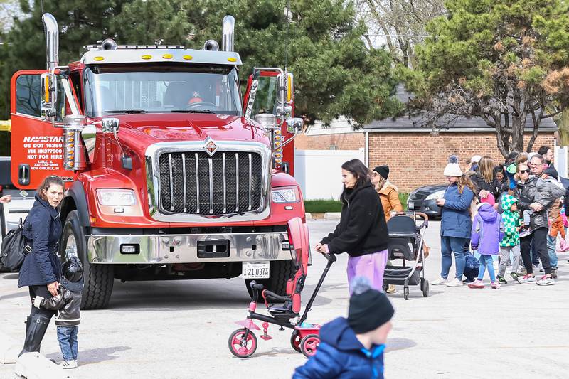 Parents stand in line with their children to enter a crane truck at the La Grange Touch a Truck event. April 22, 2023.
