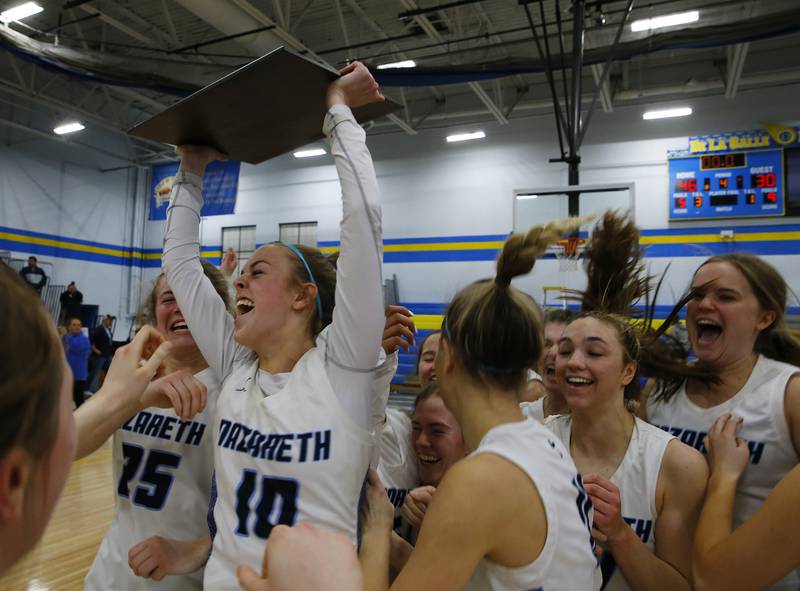 Nazareth celebrates after winning the girls IHSA 3A Supersectional basketball game between Nazareth Academy and Fenwick High School on Monday, February 28, 2022 at De La Salle High School in Chicago.