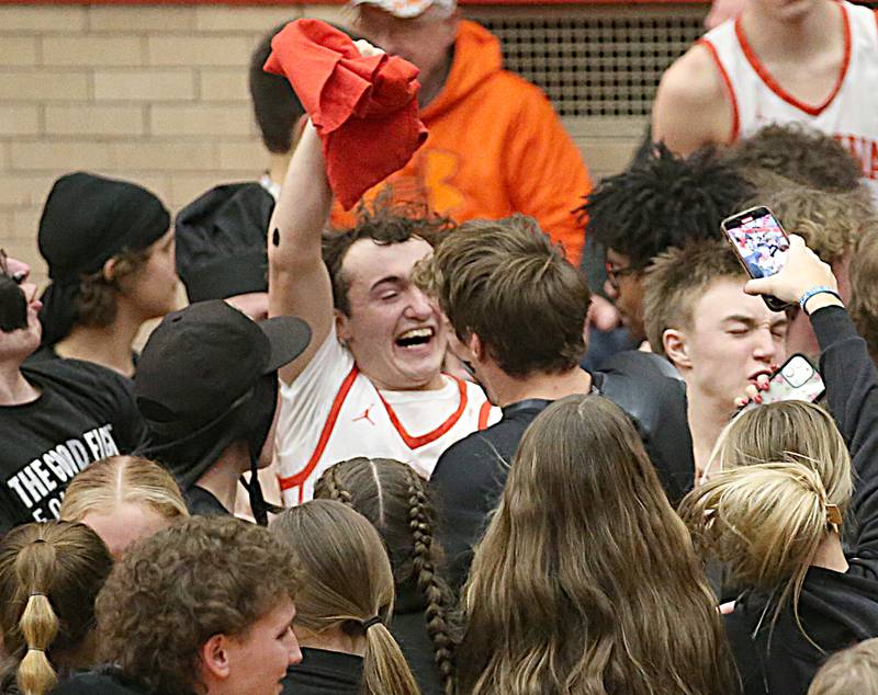 Ottawa's Levi Sheehan and Huston Hart celebrate with superfans after defeating L-P in Kingman Gymnasium on Friday, Feb. 10, 2023 at Ottawa High School.