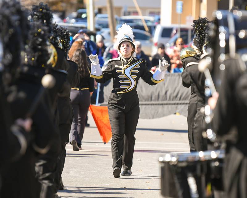 Sycamore’s drum major Emma Weimer conducts the band during annual Pumpkin Parade on Sunday Oct. 28, 2024, downtown at the 63rd annual Sycamore Pumpkin Festival.