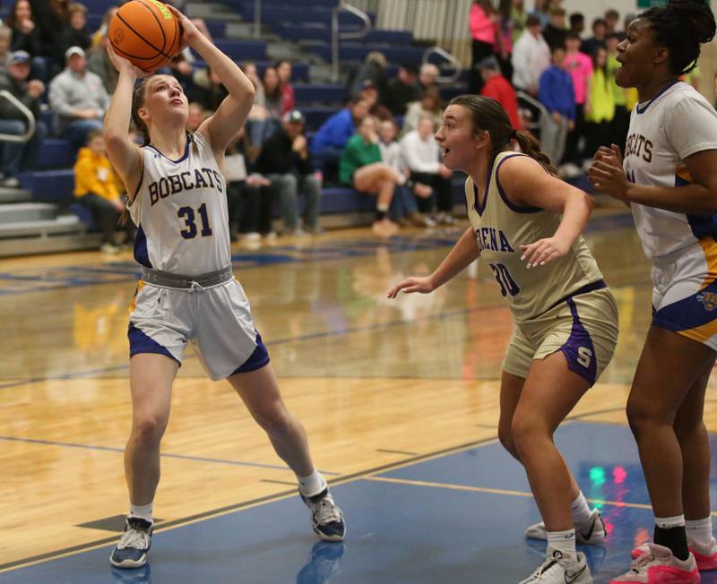 Somonuak/Leland's Allayna Wold eyes the hoop while Serena's Maddie Glade defends the lane on Monday, Feb. 10, 2025 at Somonauk High School.