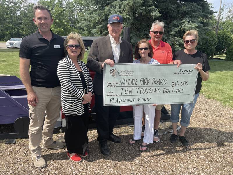 The Starved Rock Country Community Foundation recently awarded a $10,000 grant for restoration of the playground at Vittone Park in Naplate. Representing the SRCCF board are Pierre Alexander (left) Vice President and Treasurer Tracy Bedeker and President Reed Wilson with Naplate Volunteer Park Board representative Jill Nevins, Naplate Mayor Ross Sarti and Park Board member Cheryl Mucci.
