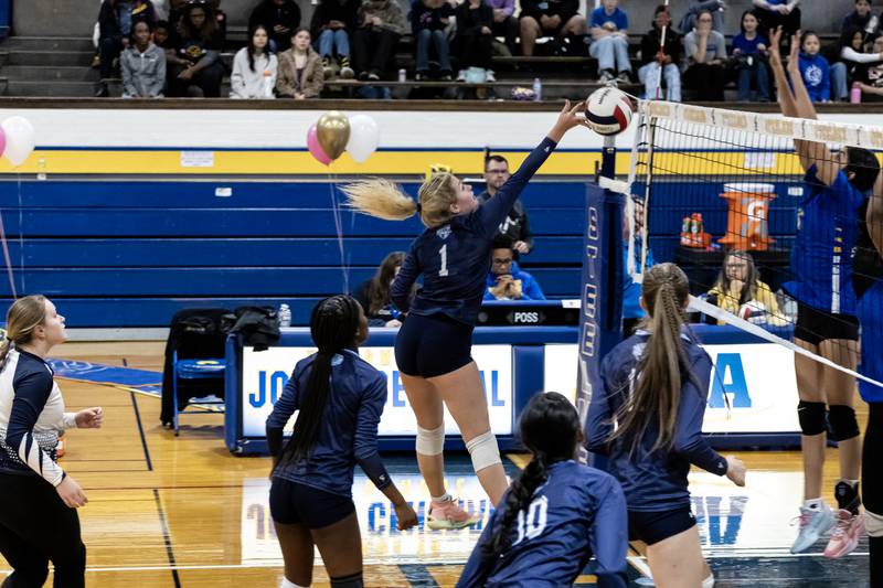 Illinois Mathematics & Science Academy's Tyra Church attempt to tap the ball over the net during a varsity volleyball game against Joliet Central at Joliet Central on Oct. 20, 2025.