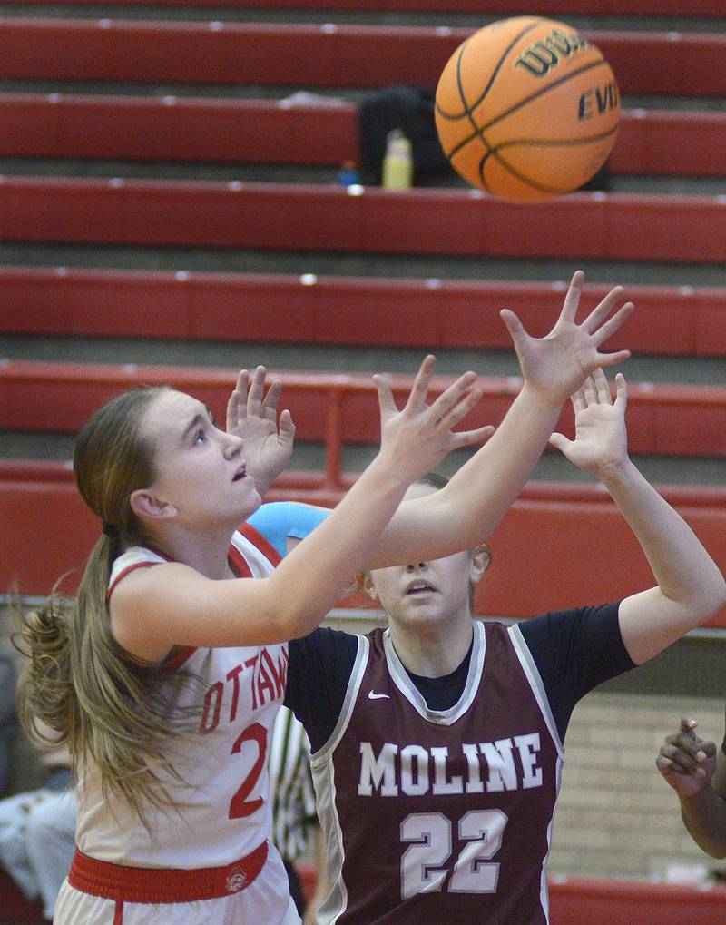 Ottawa’s Ashlynn Ganiere reaches for this rebound ahead of Moline’s Elle Machado in the 2nd period Tuesday at Ottawa.