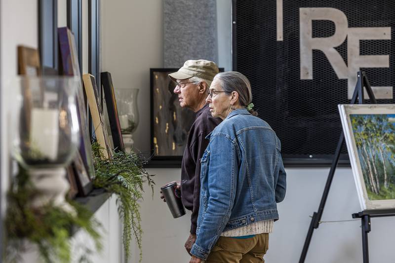 Jeff and Diane Haugen of Brookville look over some of the works Wednesday, April 10, 2024 while setting up for the Art Dash fundraiser.