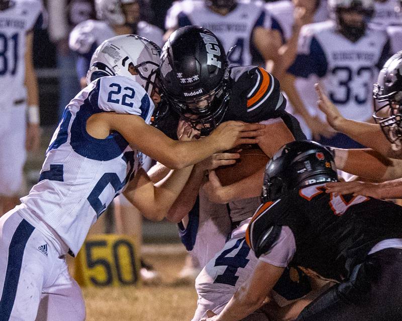 Crew Roberson of Ridgewood holds Brezdyn Simons (23) of FCW as he tries to runs ball on Friday, Sept. 26, 2025, at Woodland School in rural Streator.