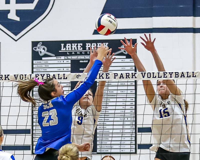 Wheaton North's Olivia Zamis (15) attempts a block on St. Charles North's Haley Burgdorf (23) kill attempt during Class 4A Lake Park Regional final volleyball match between Wheaton North at St Charles North.  Oct 31, 2024  in Roselle.