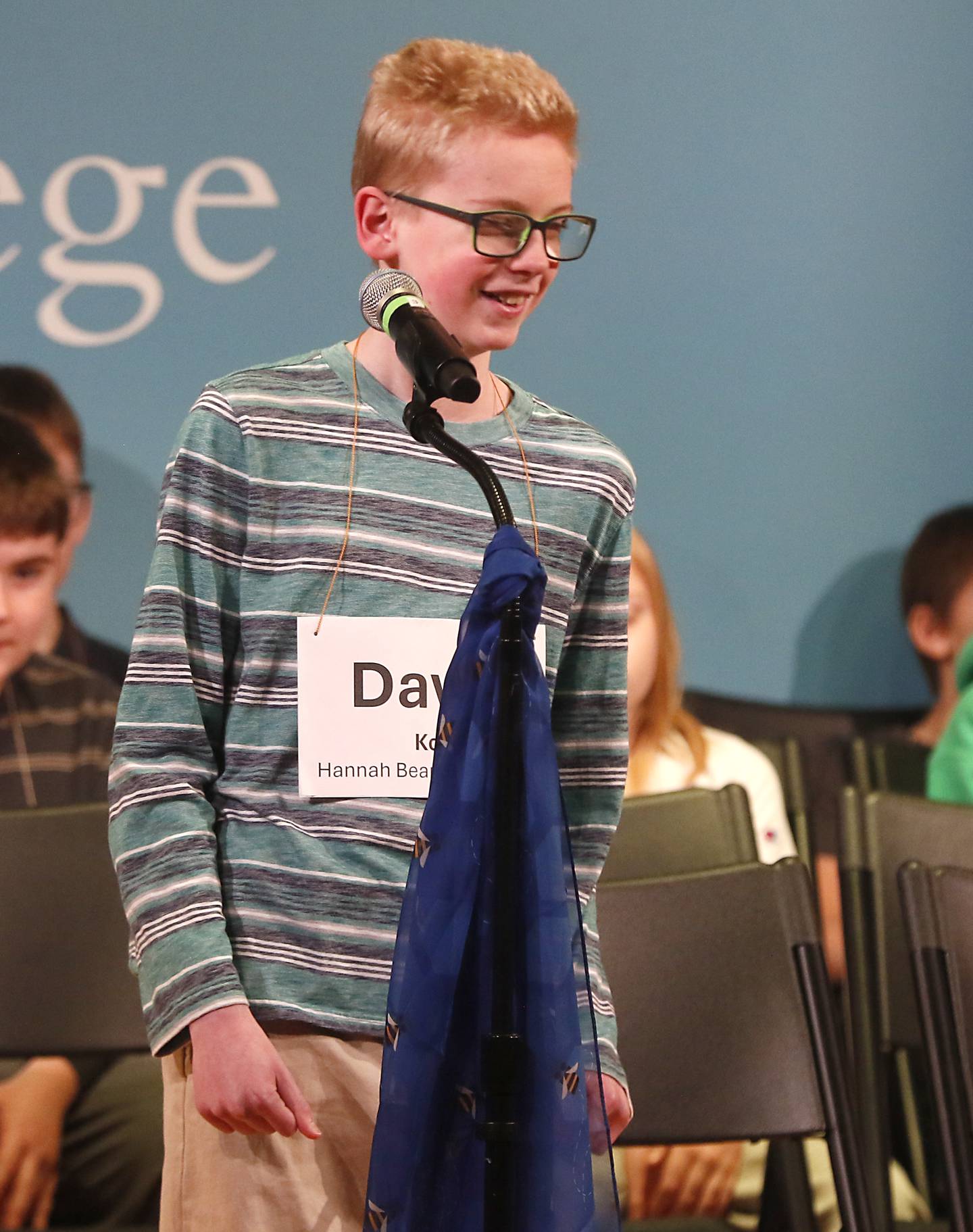 David Koll, of Hannah Beardsley School, laughs after spelling farkleberry competes in the McHenry County Regional Office of Education 2023 Spelling Bee Wednesday, March 20, 2024, at McHenry County College's Luecht Auditorium in Crystal Lake.