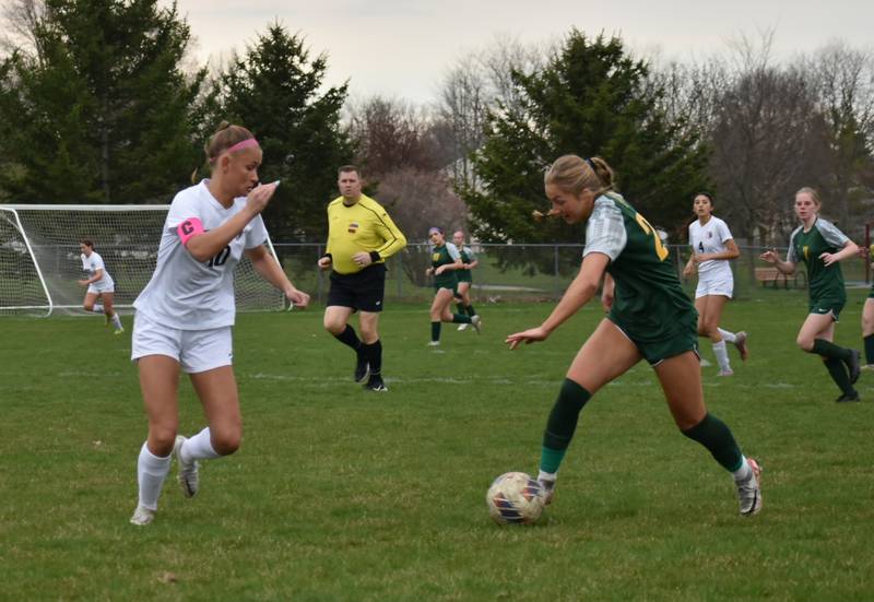 Crystal Lake South freshman Gracey LePage, right, tries to earn possession of the ball in a match against Prairie Ridge this season. LePage has found success both on the pitch and the track for the Gators this season. Photo courtesy Tracey Bestmann