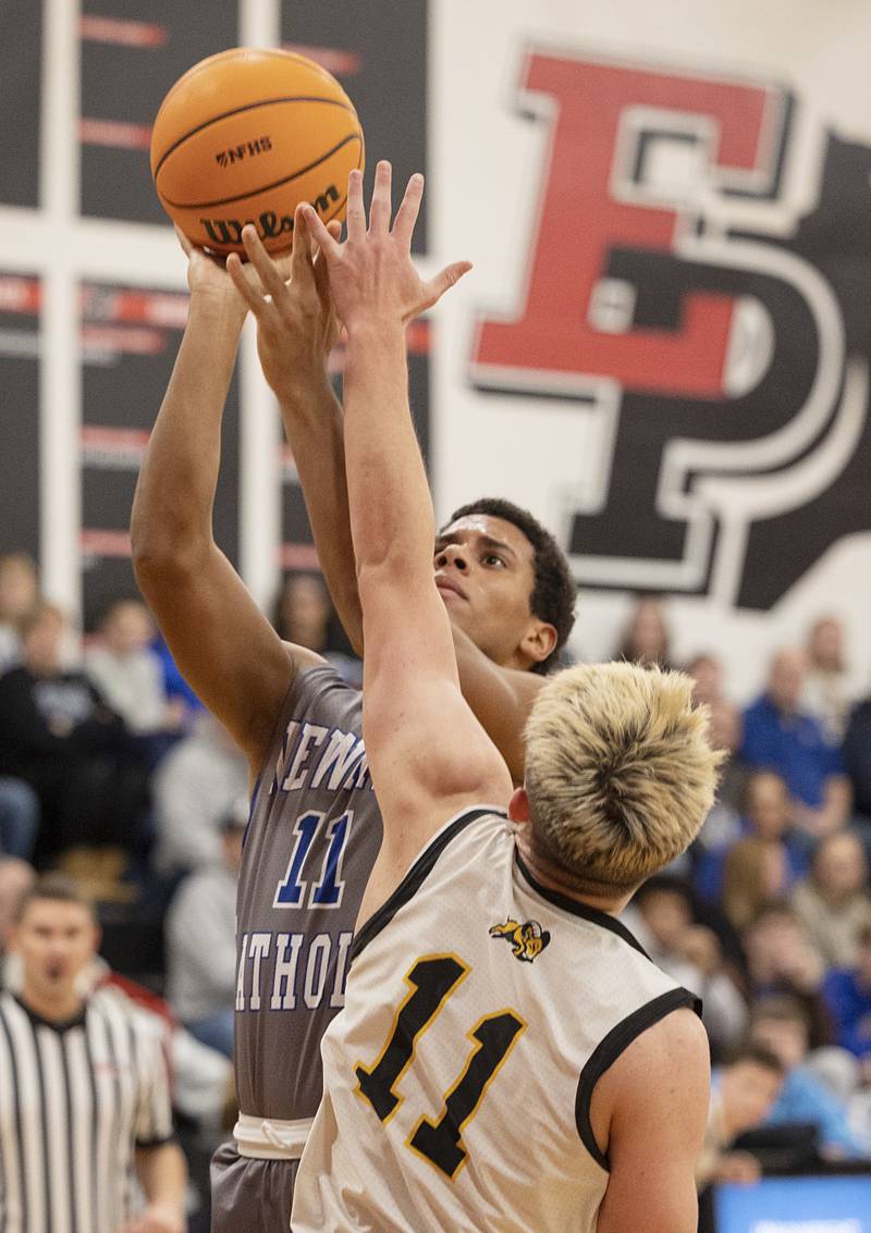 Newman’s Tyson Williams puts up a shot against Riverdale’s Brady Junis Tuesday, Dec. 30, 2025, in the final of the boys Cliff Warkins Basketball Tournament at Erie High School.