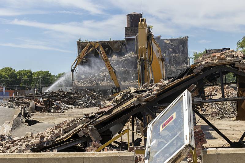 Work crews from McDonagh Demolition continue to tear down the Micro building Wednesday, Aug. 21, 2024, in downtown Rock Falls.