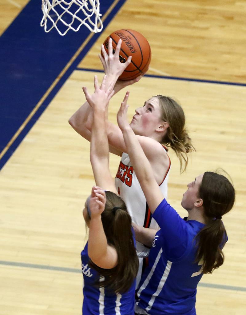 Crystal Lake Central's Ruby Macke shoots the ball as she is defended by Burlington Central's Savannah Scheuer and Audrey LaFleur during the IHSA Class 3A Woodstock Regional Championship girls basketball game on Thursday, Feb. 15, 2024, at Woodstock High School.