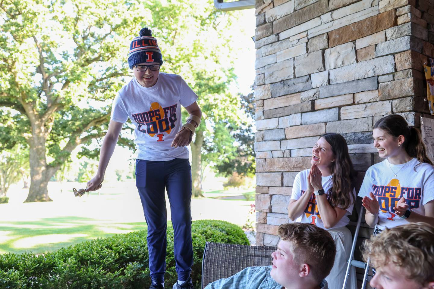 Cooper Freedlund, 13, of Bourbonnais, rings a bell in front of family and friends celebrating the end of his chemotherapy on June 28, 2025, as his sister, Reese, 18, right, and mother, Jamie, cheer him on. Jamie is the founder of Mattea's Joy, an organization that aims to help parents with children in the hospital.