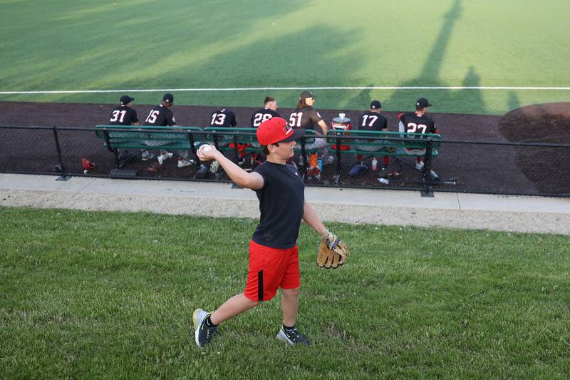 Nash Baudek, 10, from Plainfield, plays catch near the bullpen for the Ottawa Titans at the home opener for the Joliet Slammers. Friday, May 13, 2022, in Joliet.
