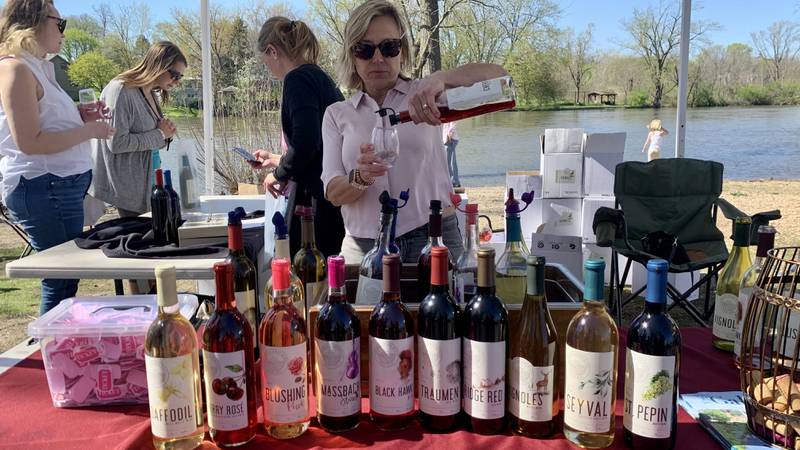 Massbach Ridge Winery serving a variety of their wines at the annual Wine on the Fox event at Hudson Crossing Park downtown Oswego May 7 and 8.
